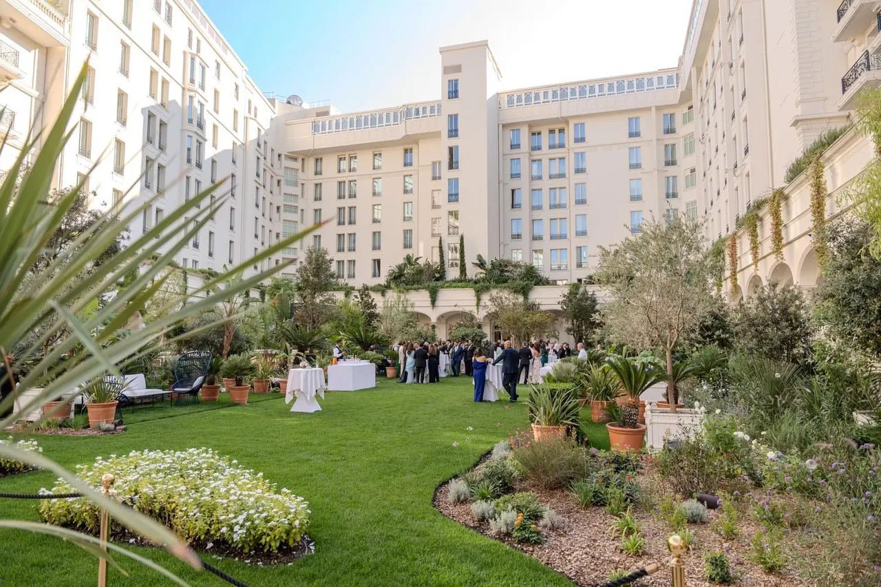 Garden cocktail reception in a palace courtyard at a corporate event