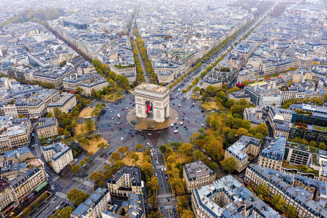 Aerial view of the Arc de Triomphe and Paris avenues in autumn light