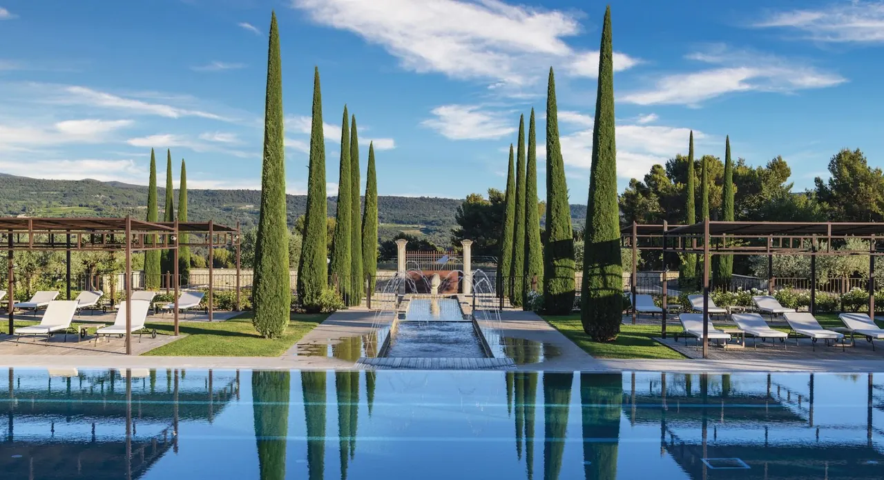 Infinity pool lined with cypress trees at a Provencal estate