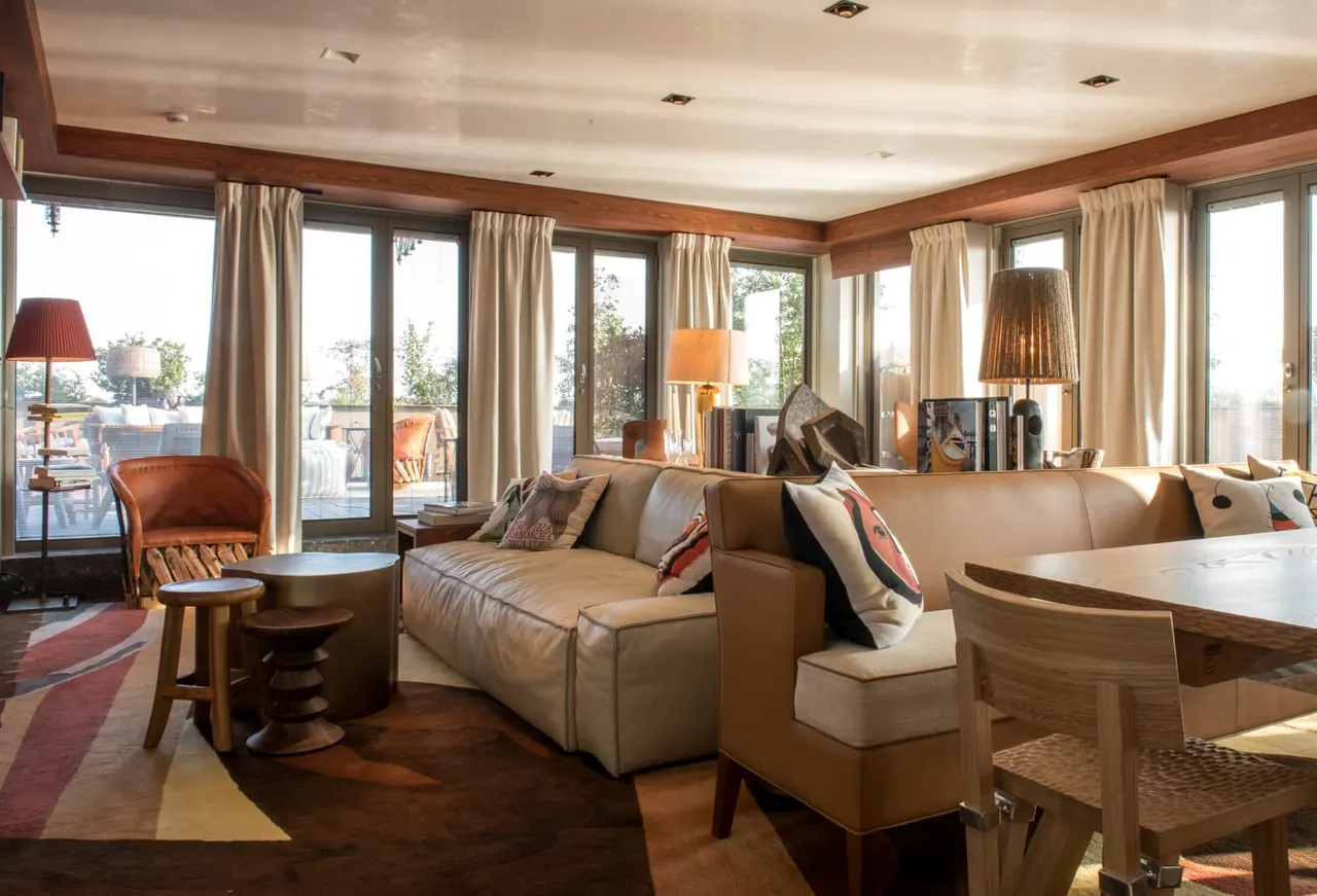 Elegant Parisian hotel suite living room opening onto a private terrace