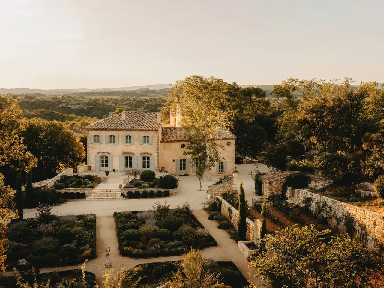 Historic Provencal manor house and formal gardens at golden hour