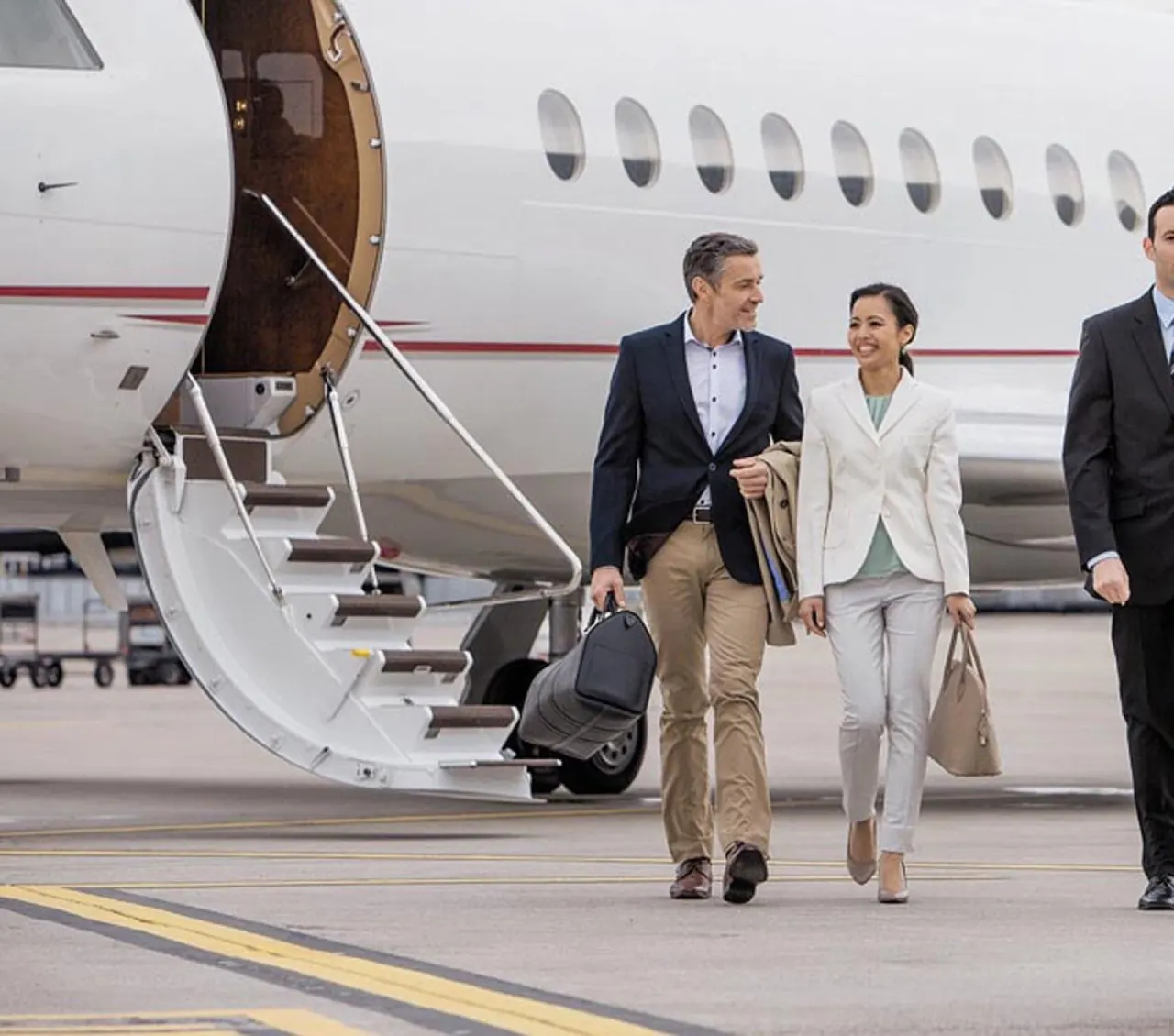 Travellers being met planeside as they disembark a private jet